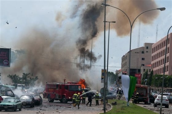 Smoke and debris fill the sky seconds after a car bomb explodes alongside firemen responding to an initial car bomb that had exploded five minutes earlier, in Abuja, Nigeria, Friday, Oct. 1, 2010. Two car bombs blew up on Friday as Nigeria celebrated, killing at least seven people in an unprecedented attack on the capital by suspected militants from the country's oil region. The attacks claimed by the Movement for the Emancipation of the Niger Delta came as the president and other dignitaries sat only a 10-minute walk away. \"There is nothing worth celebrating after 50 years of failure,\" read a statement issued by the group shortly before the attack. (AP Photo)
